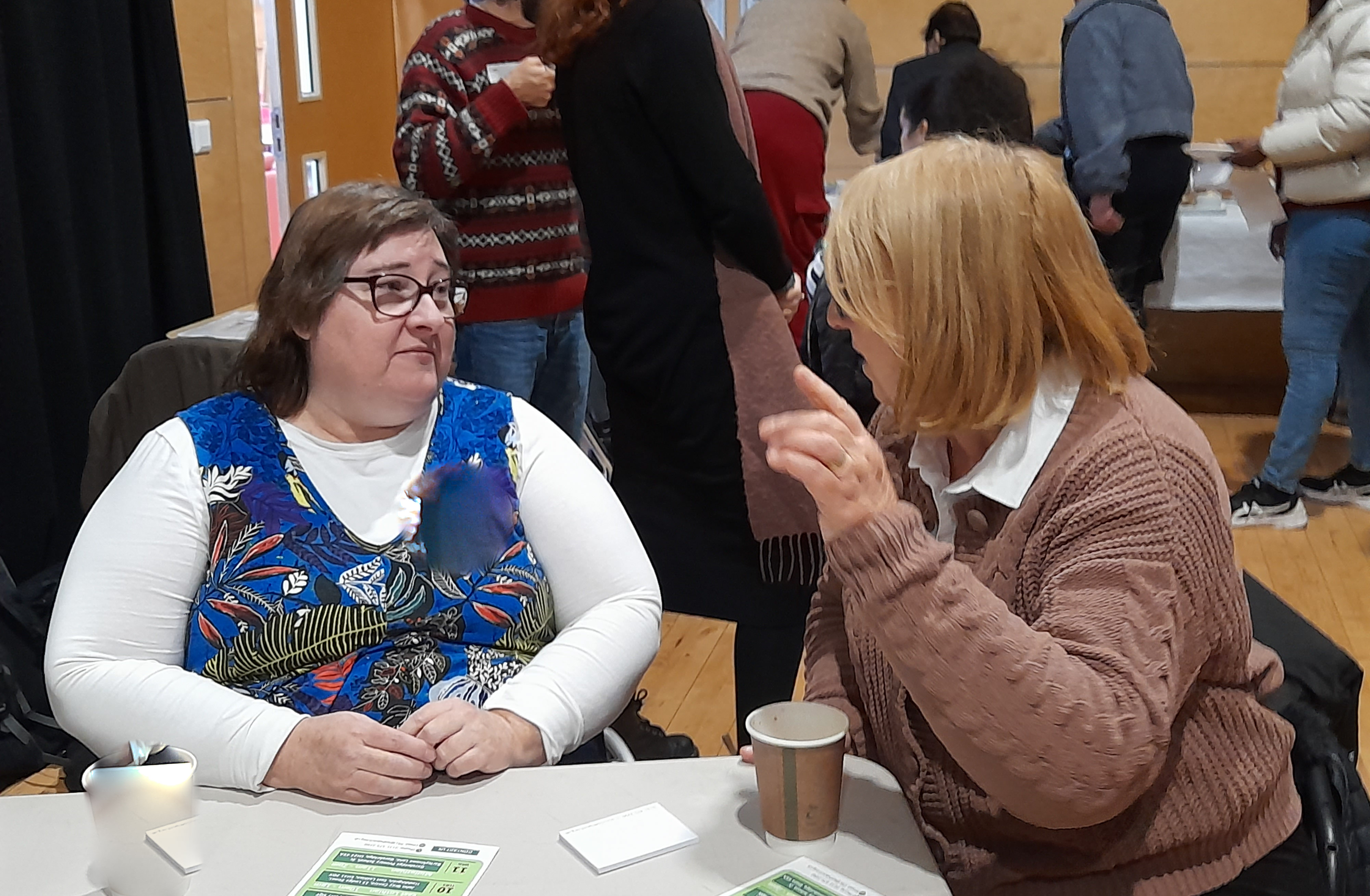 Two people talking. Image used to represent payroll service at LCiL.